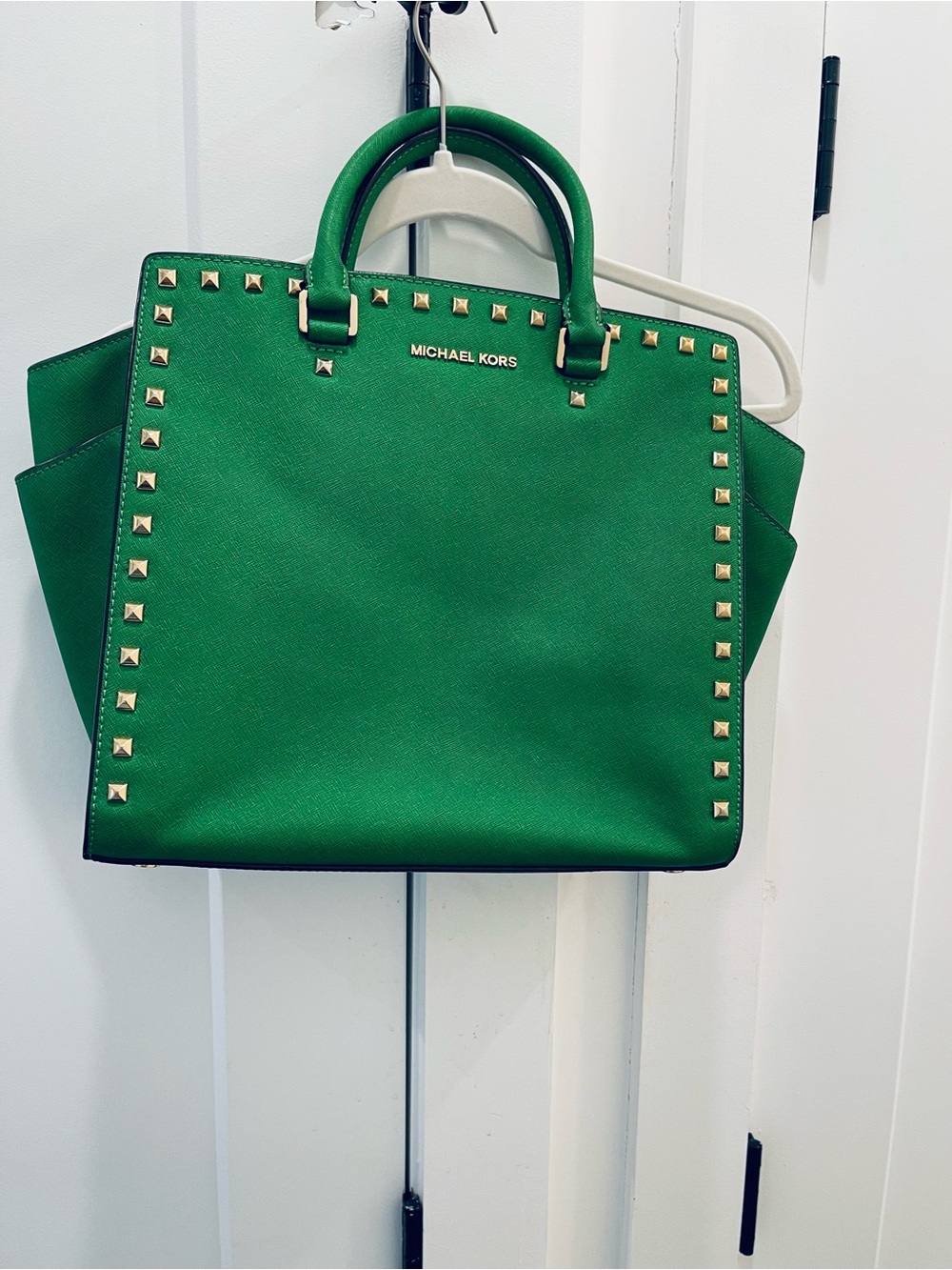 Oversized Michael Kors Selma Studded handbag featuring gold-tone grommet details